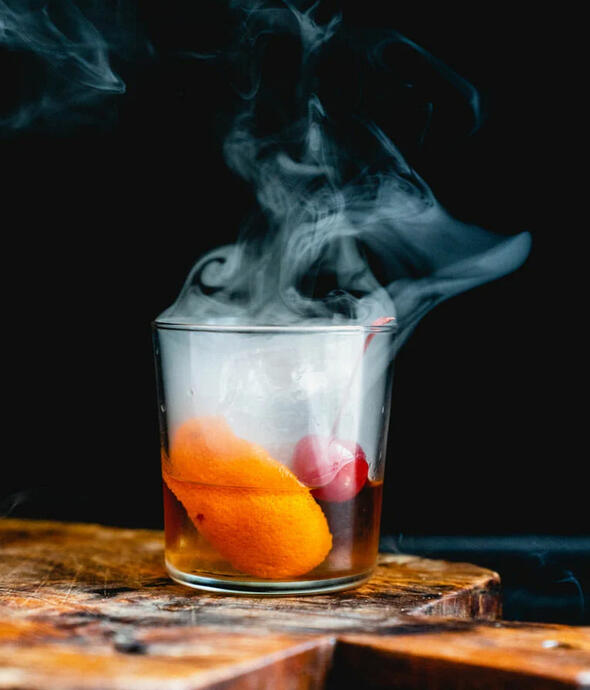 ☠ Void Smoked Old Fashioned: 1 tsp of sugar 1 tbs orange bitters 1 tsp imported liquid voidsent blood (can sub in liquid smoke on request) 2 oz. whiskey Served with La Noscean blood orange for garnish.